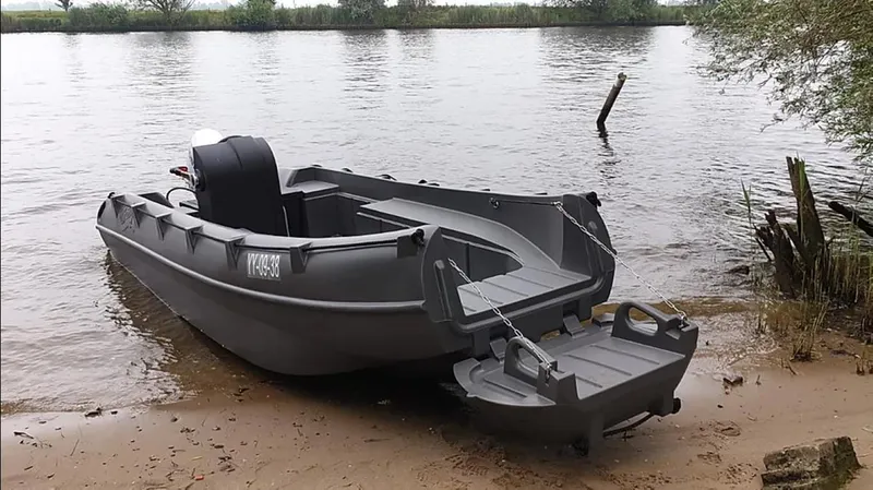 Slide: The Image of 2023 Whaly 455 R boat on sandy riverbank, ready for water adventure. - 0