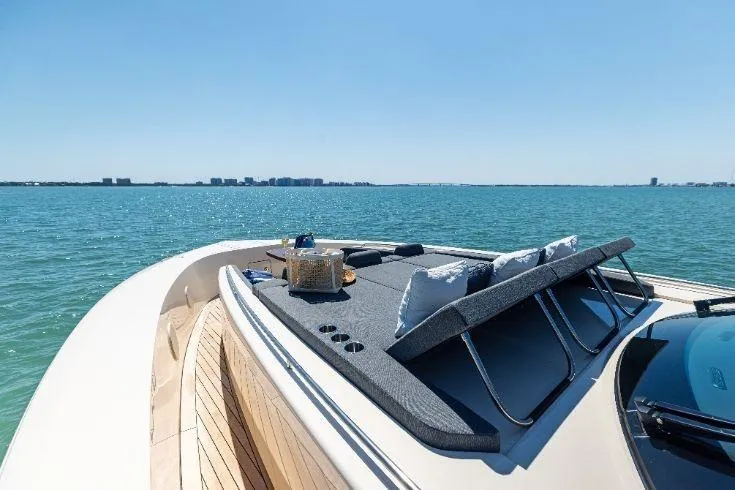 Slide: The Image of 2026 Scout 670 LXS luxury yacht with sunbathing deck on serene ocean waters. - 11