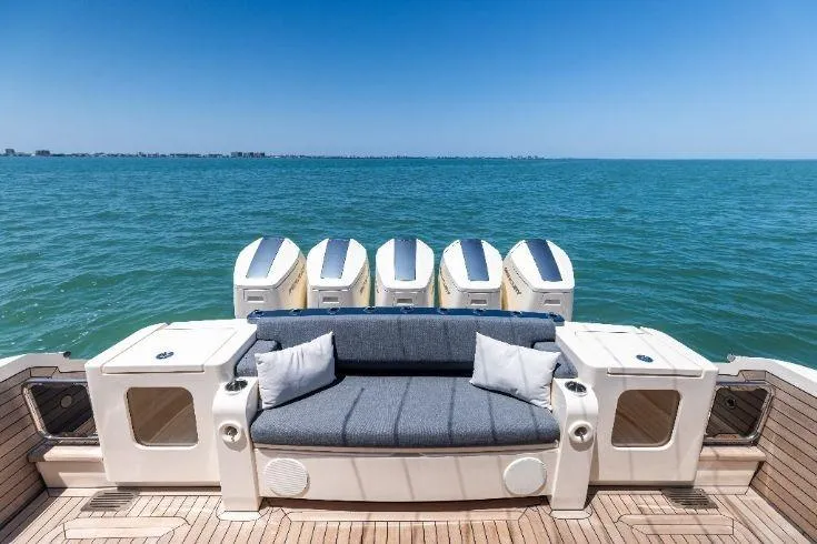 Slide: The Image of Luxury 2026 Scout 670 LXS boat with plush seating and multiple engines on open water. - 16