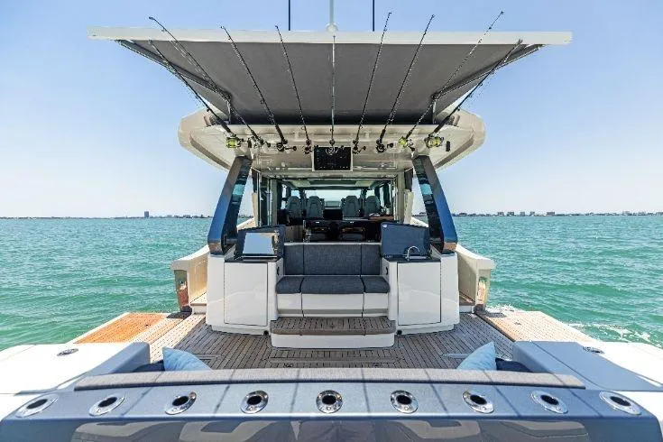 Slide: The Image of 2026 Scout 670 LXS luxury yacht on open water, showcasing spacious deck and seating. - 22