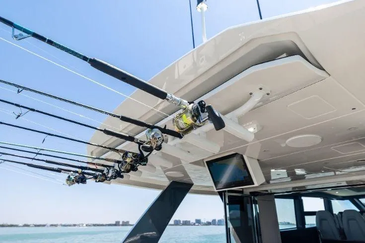 Slide: The Image of 2026 Scout 670 LXS boat with fishing rods and ocean view. - 23