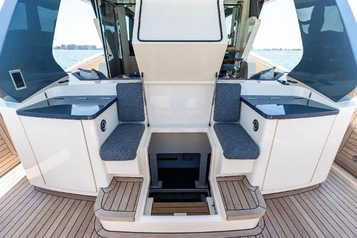 Slide: The Image of 2026 Scout 670 LXS boat interior with seating and storage, featuring sleek design and wood accents. - 27
