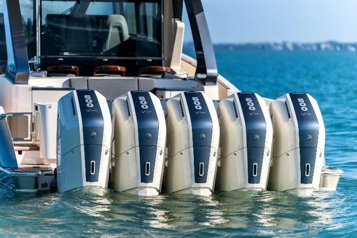 Slide: The Image of 2026 Scout 670 LXS boat with five powerful outboard engines on the water. - 3