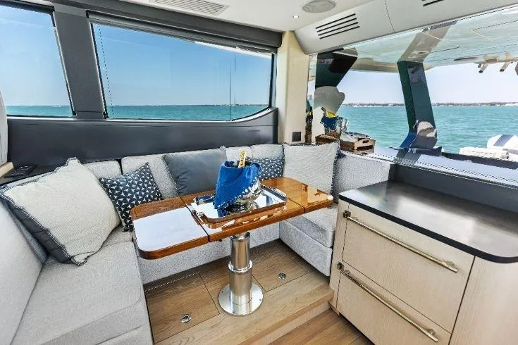 Slide: The Image of Luxurious interior of 2026 Scout 670 LXS yacht with ocean view and elegant seating area. - 34