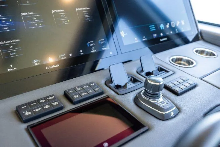 Slide: The Image of 2026 Scout 670 LXS boat dashboard with advanced Garmin navigation displays and controls. - 40