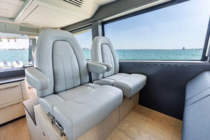 Slide: The Image of Luxurious interior seating of 2026 Scout 670 LXS boat with ocean view. - 43