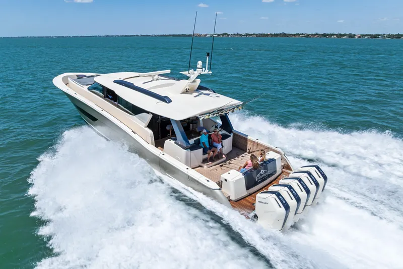 Slide: The Image of 2026 Scout 670 LXS yacht cruising on open water with passengers enjoying the ride. - 5