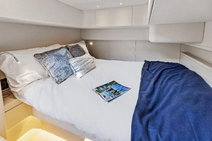 Slide: The Image of Luxurious cabin interior of 2026 Scout 670 LXS yacht with cozy bedding. - 54