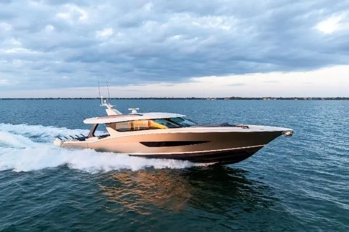 Slide: The Image of 2026 Scout 670 LXS luxury yacht cruising on open water under a cloudy sky. - 6