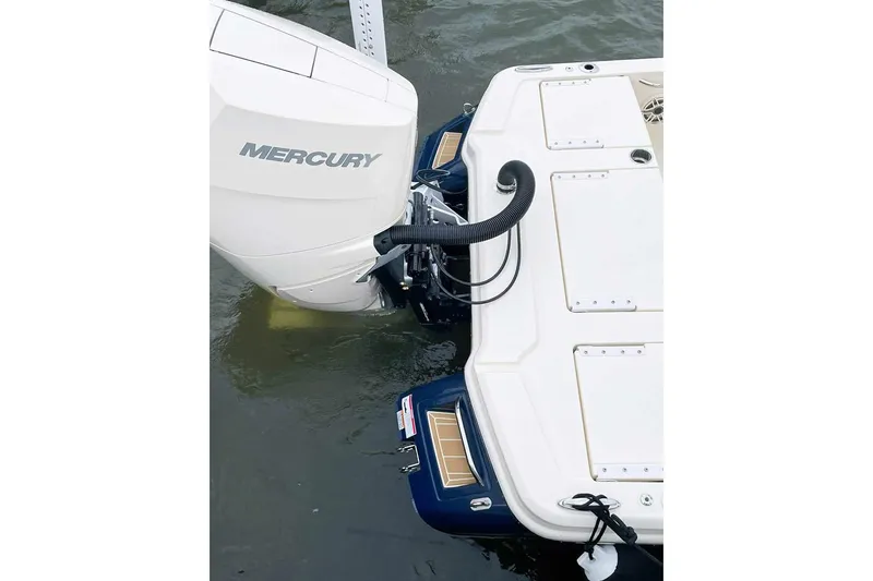 Slide: The Image of 2026 Scout 261 XSS boat interior with seating and cup holders, parked on gravel. - 10