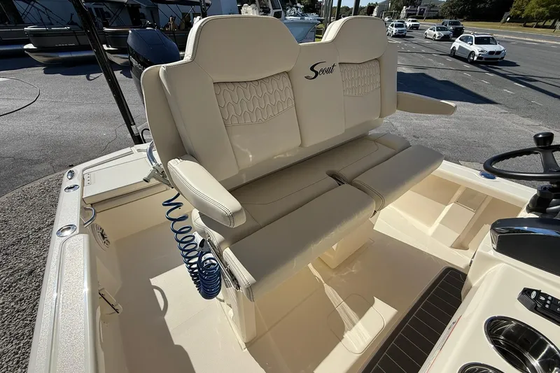 Slide: The Image of 2026 Scout 261 XSS boat interior with beige seating and steering wheel. - 13