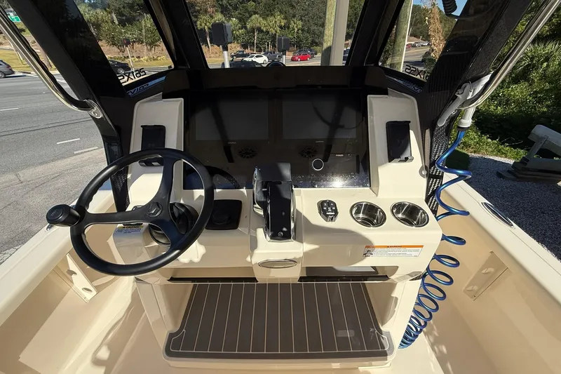Slide: The Image of 2026 Scout 261 XSS boat dashboard with steering wheel and control panel. - 14