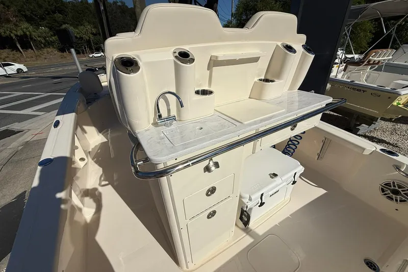 Slide: The Image of 2026 Scout 261 XSS boat interior with sink, storage, and cup holders. - 17