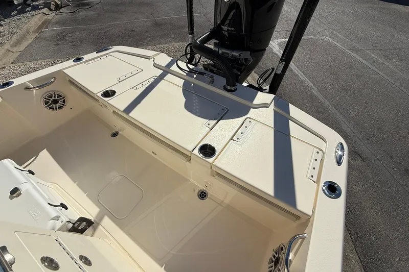 Slide: The Image of 2026 Scout 261 XSS boat interior with storage compartments and motor. - 18