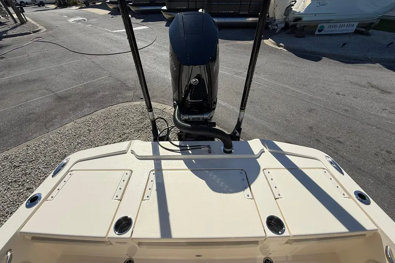 Slide: The Image of 2026 Scout 261 XSS boat with powerful outboard motor, docked on a sunny day. - 20