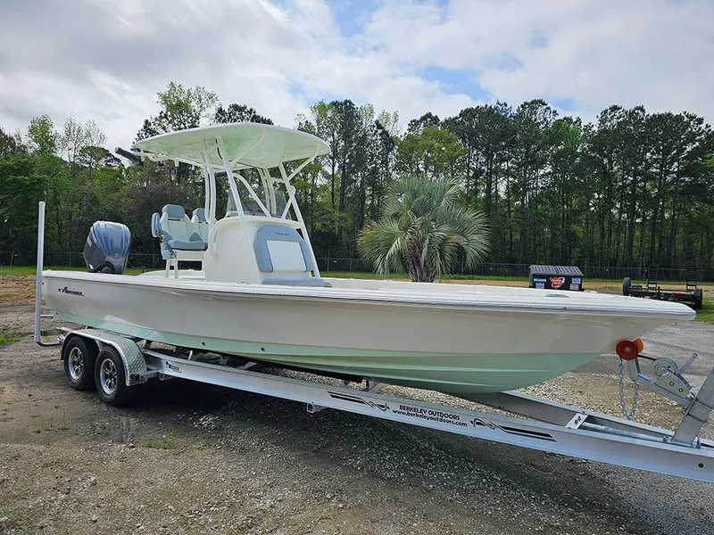 The Image of 2025 Avenger AV26 boat on trailer, parked outdoors with trees in the background. - 1