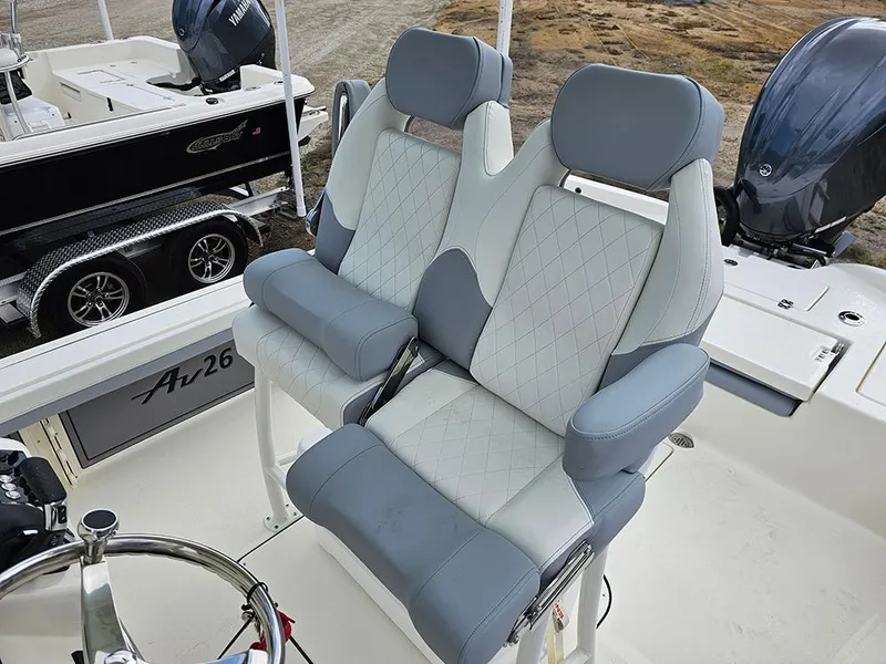 Slide: The Image of Luxury seating on 2025 Avenger AV26 boat, featuring dual cushioned seats with diamond stitching. - 12