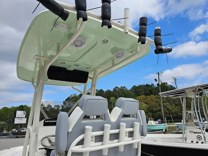 Slide: The Image of 2025 Avenger AV26 boat with T-top and rod holders under a blue sky. - 17