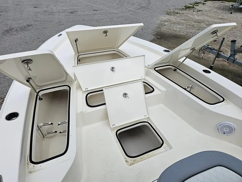 Slide: The Image of Avenger AV26 2025 boat with open storage compartments on deck. - 22