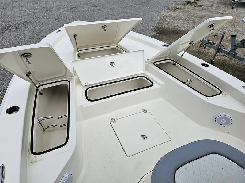 Slide: The Image of Open storage compartments on a 2025 Avenger AV26 boat deck. - 23