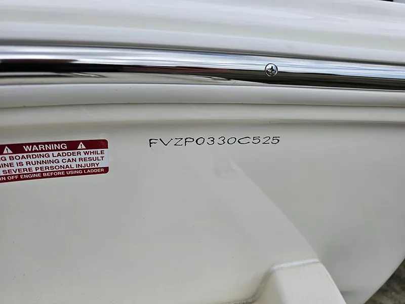 Slide: The Image of 2025 Avenger AV26 boat hull with warning label and serial number. - 28