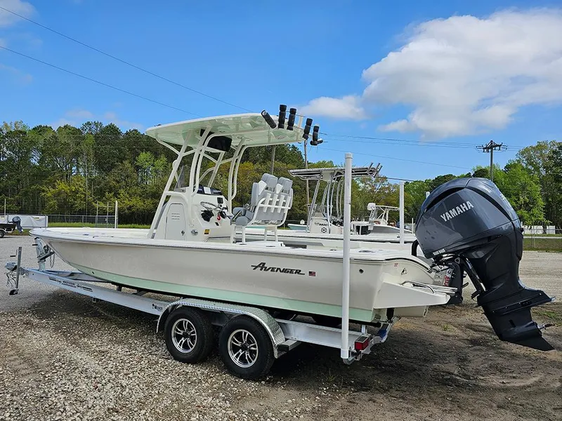 Slide: The Image of 2025 Avenger AV26 boat with Yamaha engine on trailer, parked outdoors. - 6