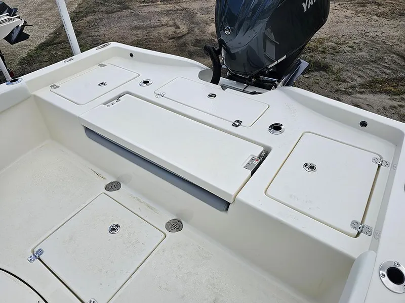 Slide: The Image of 2025 Avenger AV26 boat deck with storage compartments and Yamaha outboard motor. - 9