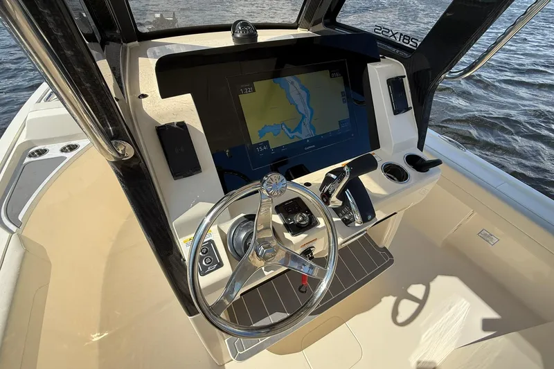 Slide: The Image of 2026 Scout 281 XSS boat dashboard with navigation screen and steering wheel. - 15