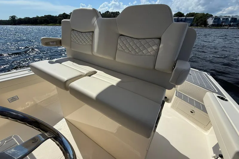 Slide: The Image of 2026 Scout 281 XSS boat interior with luxurious seating on a sunny day. - 20