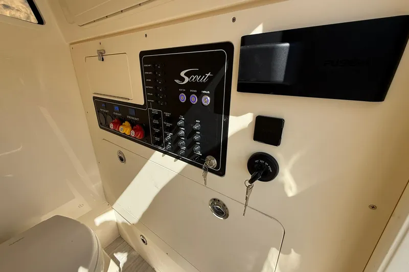 Slide: The Image of Control panel of 2026 Scout 281 XSS boat with switches and ignition keys. - 33