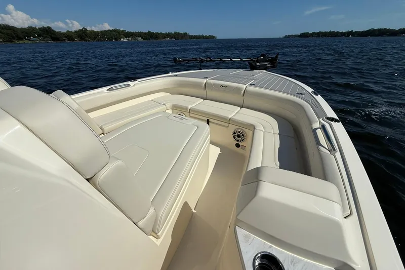 Slide: The Image of Luxurious 2026 Scout 281 XSS boat with spacious seating on a serene lake. - 4