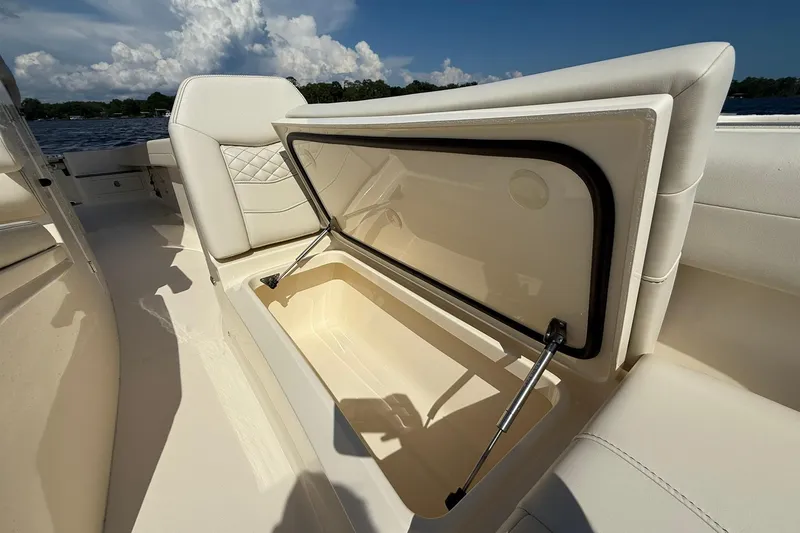 Slide: The Image of 2026 Scout 281 XSS boat interior storage compartment with open lid, showcasing spacious design. - 9