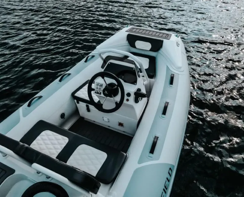 Slide: The Image of 2025 Highfield Sport 300 boat on water, featuring sleek design and modern controls. - 2