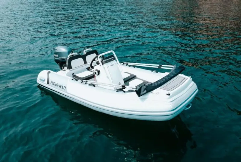 Slide: The Image of 2025 Highfield Sport 330 boat on clear blue water. - 2