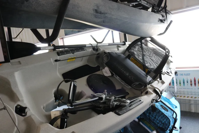 The Image of 2023 Hobie Mirage Passport 12.0 R kayak displayed indoors with accessories. - 0