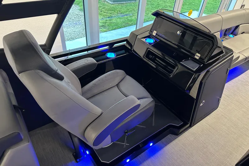Slide: The Image of Captain's chair and console of 2025 Veranda VX 27 DCRC boat with blue LED lighting. - 14