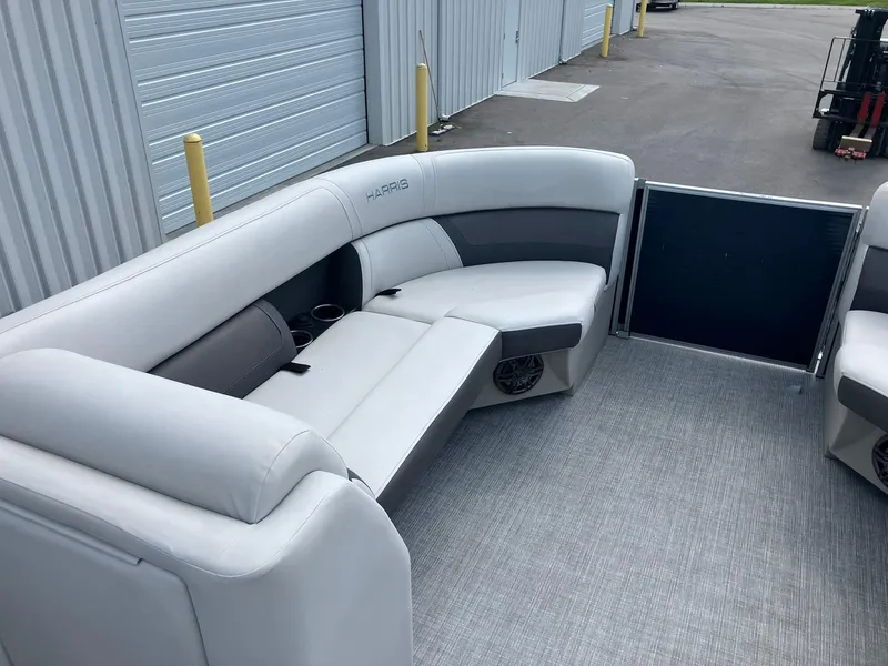 Slide: The Image of 2023 Harris Cruiser 230 boat interior with gray seating and cup holders. - 10
