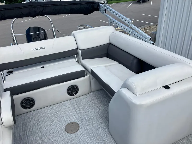 Slide: The Image of 2023 Harris Cruiser 230 boat interior with white and gray seating. - 11
