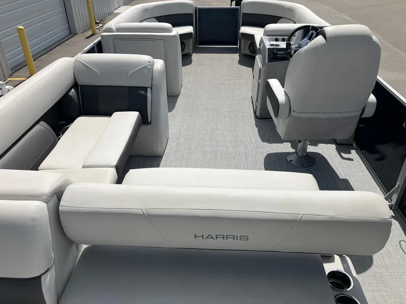 Slide: The Image of 2023 Harris Cruiser 230 pontoon boat interior with plush seating and modern helm. - 17