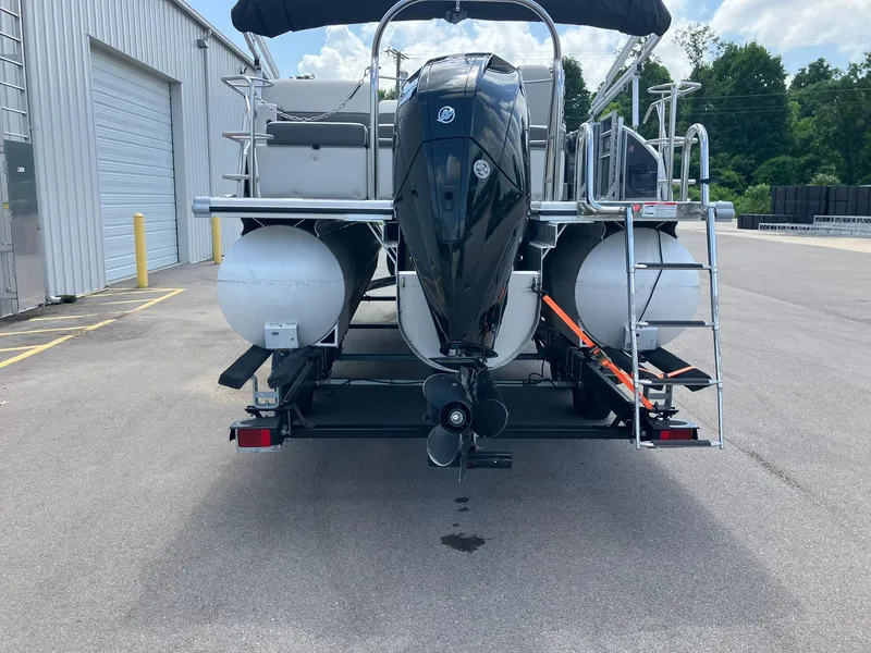 Slide: The Image of 2023 Harris Cruiser 230 pontoon boat on trailer, rear view with outboard motor. - 3