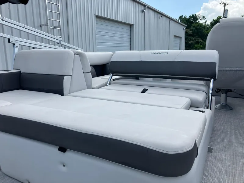 Slide: The Image of 2023 Harris Cruiser 230 boat interior with white and gray seating. - 5