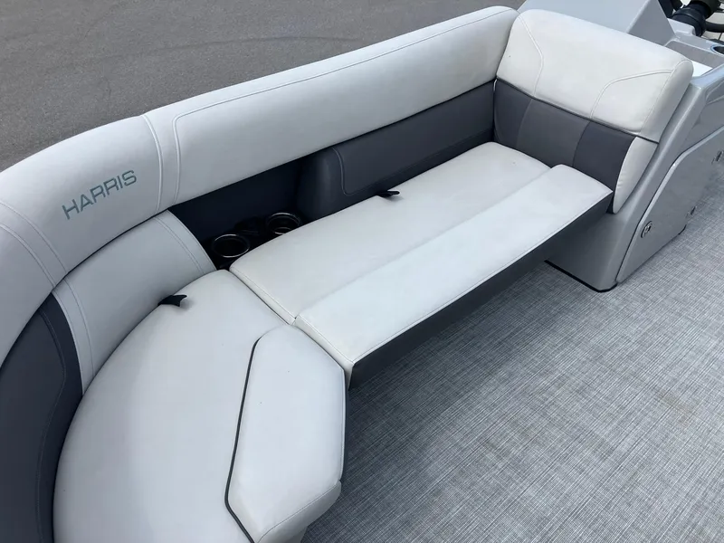 Slide: The Image of 2023 Harris Cruiser 230 boat interior with white and gray seating. - 7