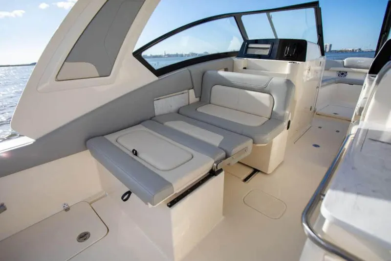 Slide: The Image of 2026 Scout 277 Dorado boat on water, showcasing sleek design and spacious interior. - 10