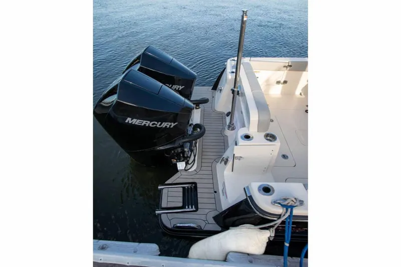 Slide: The Image of 2026 Scout 277 Dorado interior storage area with rod holders and netted compartment. - 13