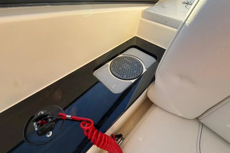 Slide: The Image of 2026 Scout 277 Dorado boat interior with wireless charging pad and safety switch. - 17