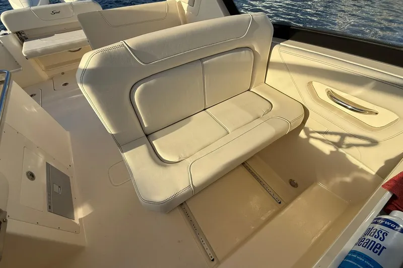 Slide: The Image of 2026 Scout 277 Dorado boat interior with beige seating and storage compartments. - 18