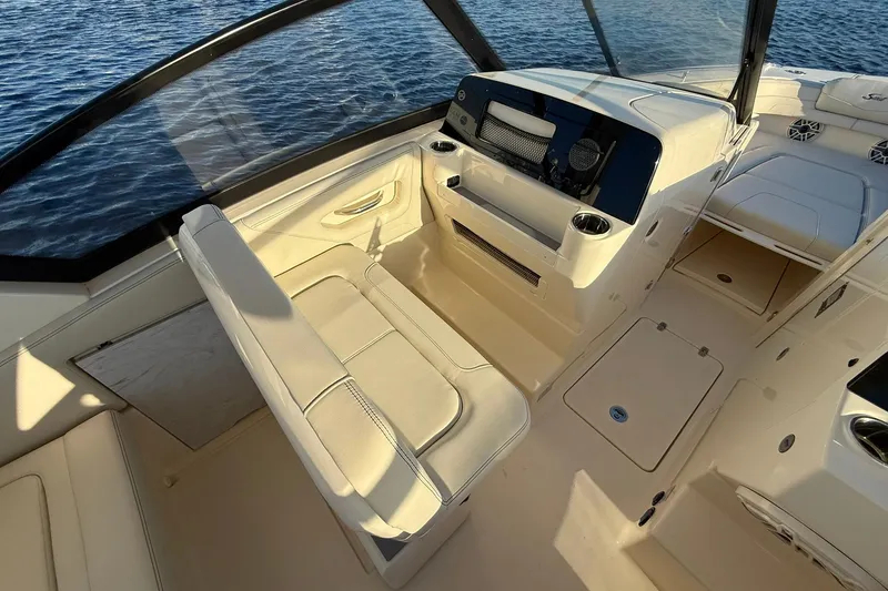 Slide: The Image of 2026 Scout 277 Dorado boat interior with beige seating and sleek dashboard design. - 19