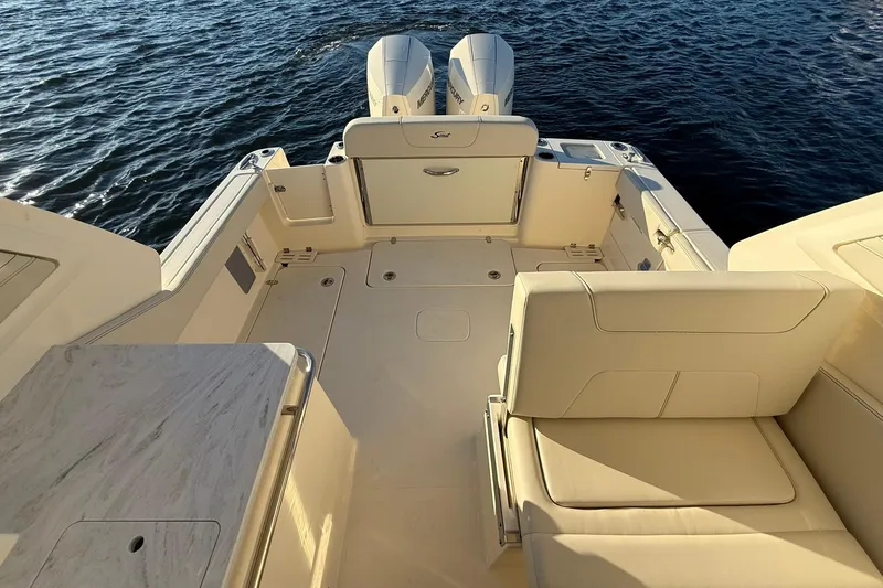 Slide: The Image of 2026 Scout 277 Dorado boat interior with seating and twin engines on water. - 26