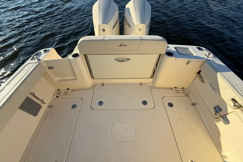 Slide: The Image of 2026 Scout 277 Dorado boat deck with dual Mercury engines on water. - 27