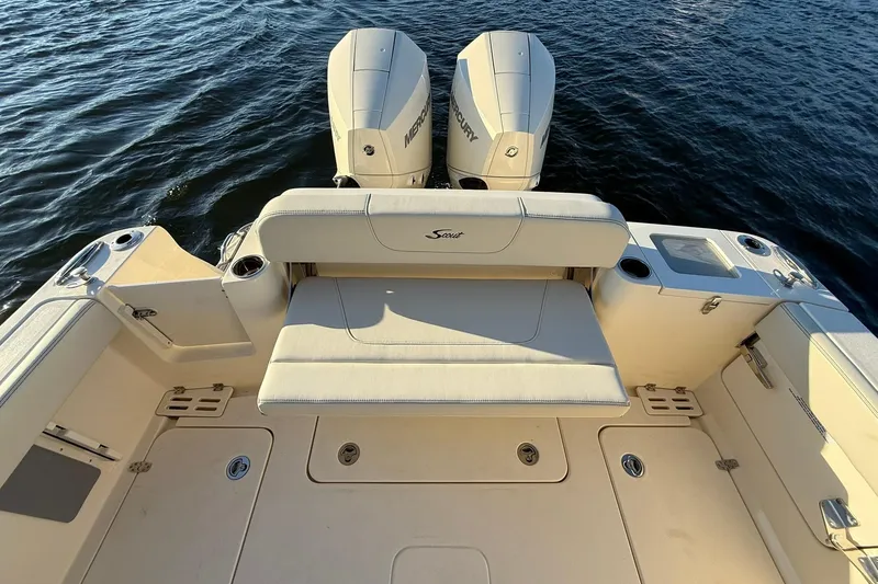 Slide: The Image of 2026 Scout 277 Dorado boat with dual Mercury engines on calm water. - 28